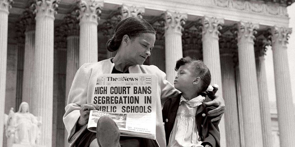 A mother and daughter sit outside the Supreme Court