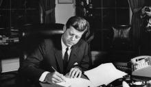 Kennedy at his desk