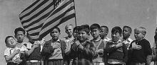 Children from different ethnic background pledging allegiance to the U.S. flag