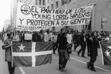 Young Lords members with a sign